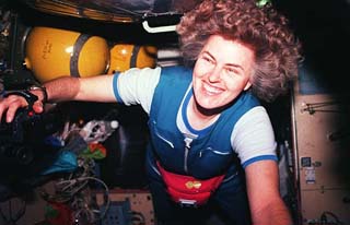 Astronaut Shannon Lucid floats through the Russian Mir space station Spektr module, a camera in her hand. 